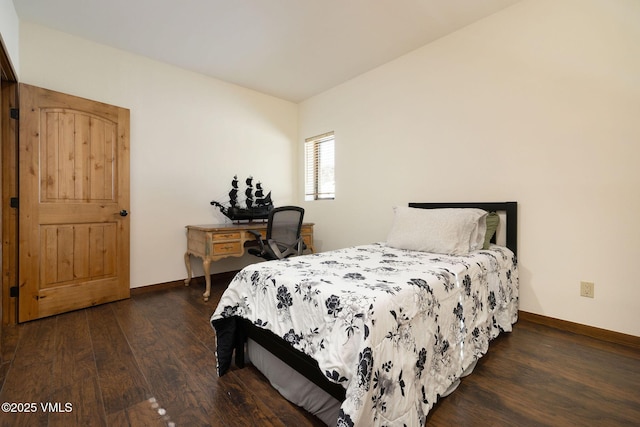 bedroom featuring baseboards and wood finished floors