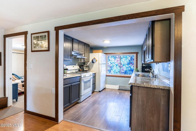 636 Valley Rd, Gypsum, CO 81637 - kitchen with white appliances, under cabinet range hood, light wood-style flooring, and light countertops
