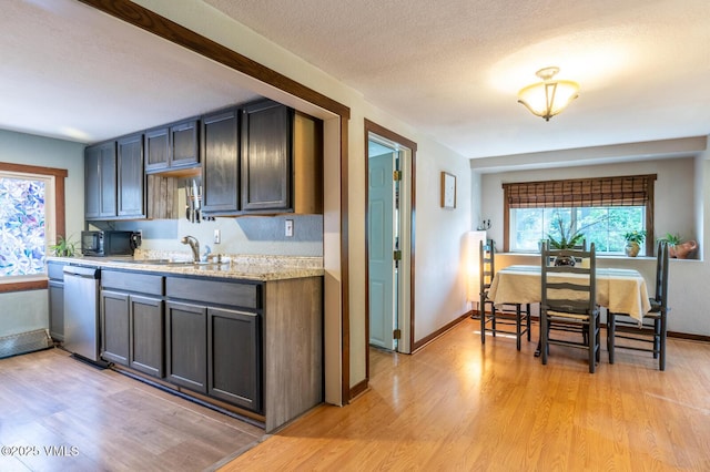 636 Valley Rd, Gypsum, CO 81637 - kitchen featuring black microwave, dishwasher, light wood-type flooring, and a textured ceiling