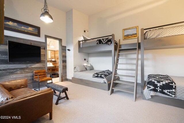 bedroom with wooden walls and carpet flooring