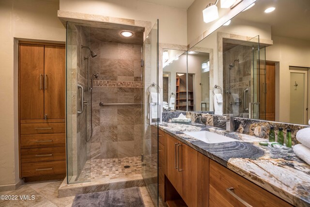 bathroom featuring vanity and an enclosed shower