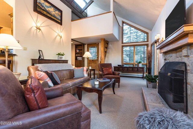 living room featuring a fireplace, carpet flooring, and high vaulted ceiling