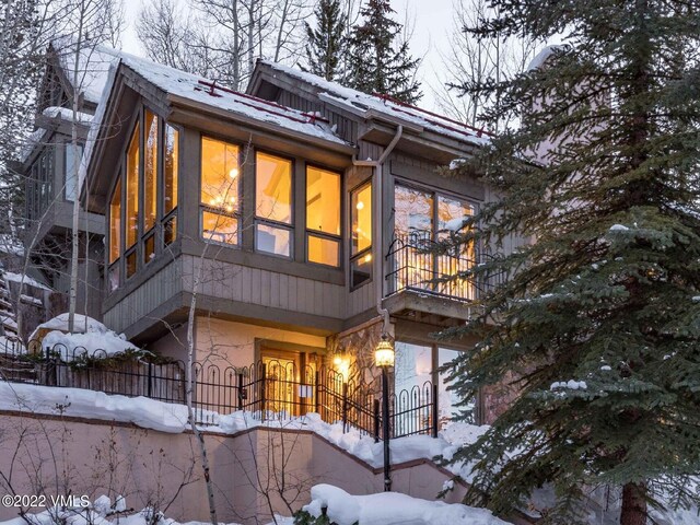 snow covered property featuring a balcony