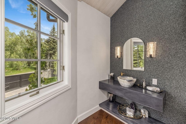 1531 Lake Creek Rd, Edwards, CO 81632 - bathroom featuring vaulted ceiling, healthy amount of natural light, wood finished floors, and tasteful backsplash