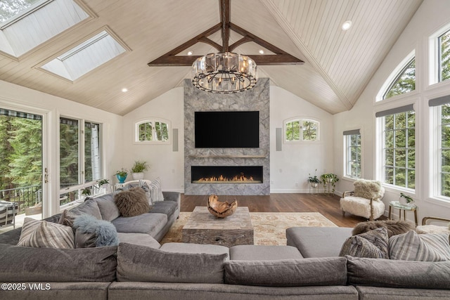 1531 Lake Creek Rd, Edwards, CO 81632 - living room with healthy amount of natural light, wood finished floors, a chandelier, a fireplace, and high vaulted ceiling