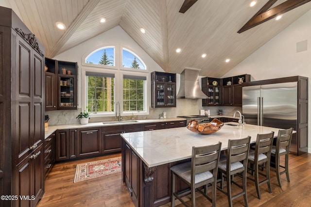 1531 Lake Creek Rd, Edwards, CO 81632 - kitchen featuring a sink, wall chimney exhaust hood, an island with sink, dark wood finished floors, and high vaulted ceiling
