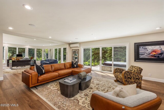 1531 Lake Creek Rd, Edwards, CO 81632 - living room with a wall unit AC, wood finished floors, recessed lighting, and baseboards