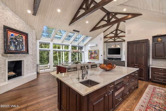1531 Lake Creek Rd, Edwards, CO 81632 - kitchen featuring high vaulted ceiling, stainless steel microwave, a sink, open floor plan, and beam ceiling