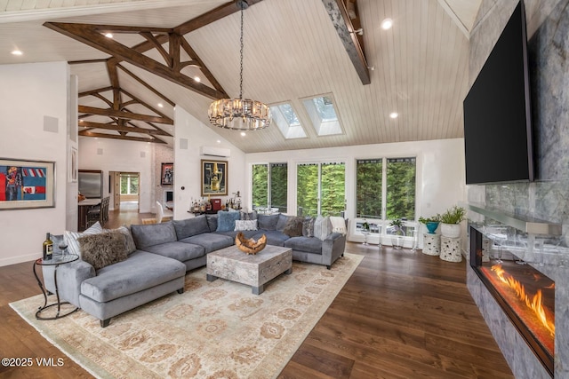 1531 Lake Creek Rd, Edwards, CO 81632 - living room with high vaulted ceiling, a fireplace, wood finished floors, beam ceiling, and a skylight