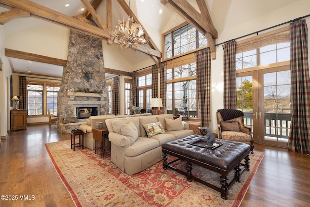 273 Bearden Rd, Edwards, CO 81632 - living area with an inviting chandelier, a fireplace, beam ceiling, high vaulted ceiling, and wood finished floors