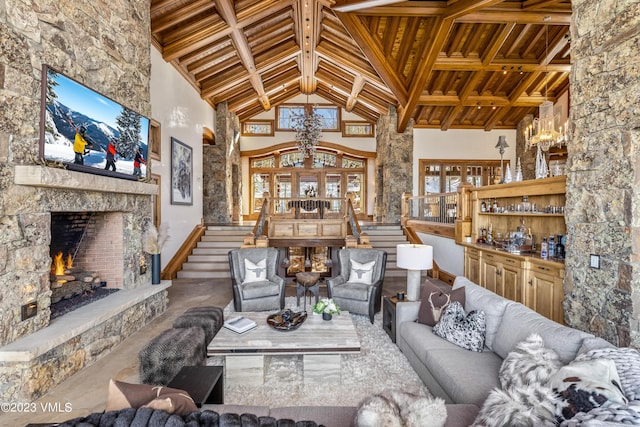 living room with high vaulted ceiling, a fireplace, wooden ceiling, and beamed ceiling