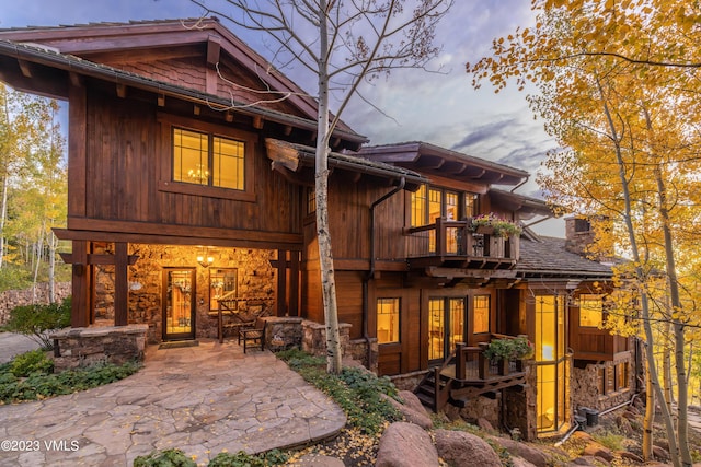 back of house with a balcony and a patio area