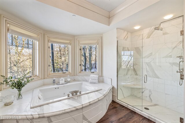 bathroom featuring plus walk in shower and hardwood / wood-style floors