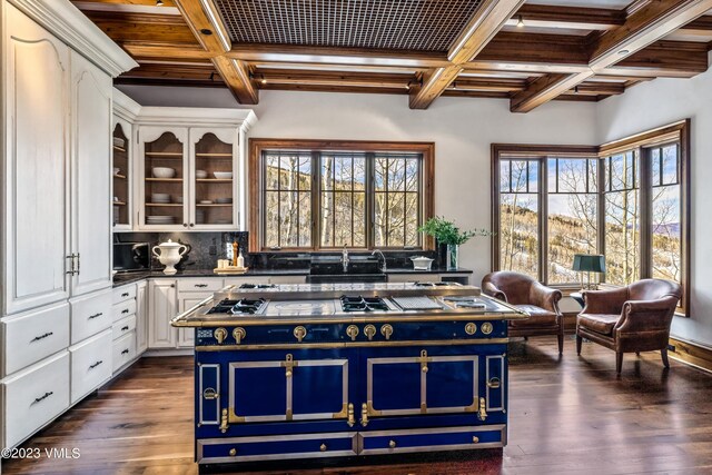 kitchen with blue cabinets, dark wood-type flooring, white cabinets, and a kitchen island