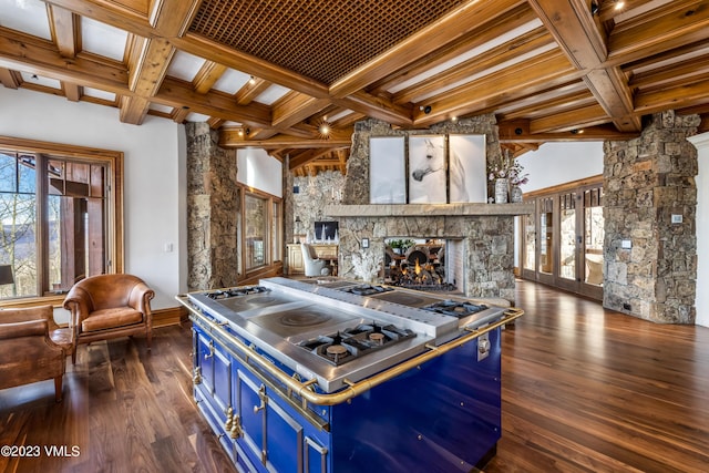 kitchen featuring coffered ceiling, a multi sided fireplace, blue cabinetry, and dark wood-type flooring