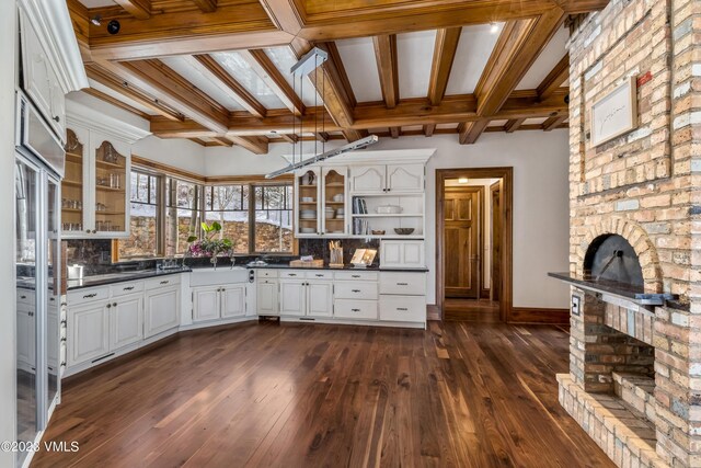 kitchen featuring white cabinetry, coffered ceiling, dark hardwood / wood-style flooring, decorative backsplash, and beamed ceiling