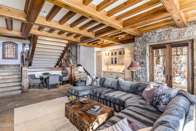 living room featuring coffered ceiling, french doors, and beamed ceiling