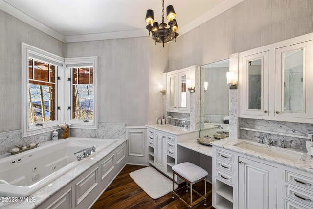 bathroom with hardwood / wood-style flooring, vanity, a bathing tub, and a notable chandelier