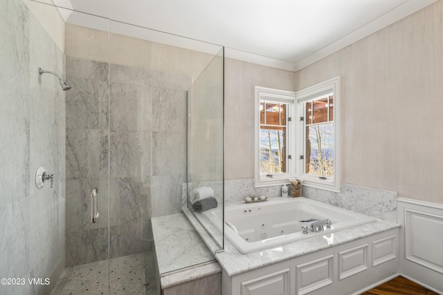 bathroom featuring ornamental molding and separate shower and tub