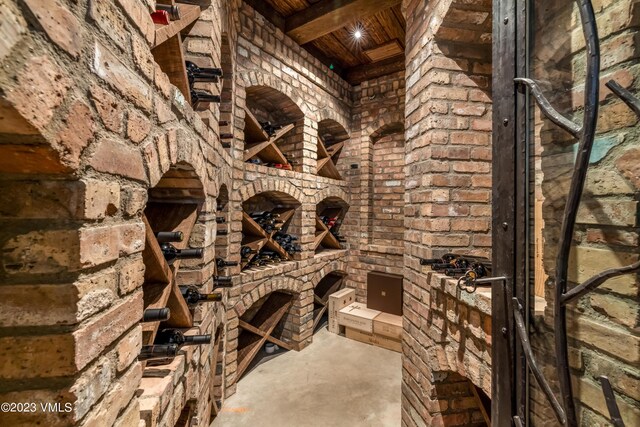 wine cellar featuring wood ceiling and beam ceiling