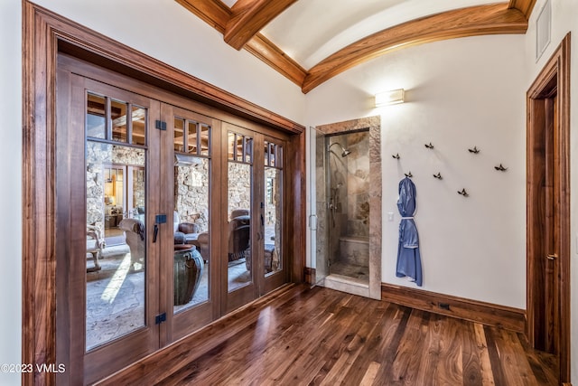 foyer entrance featuring lofted ceiling, crown molding, dark hardwood / wood-style floors, and french doors