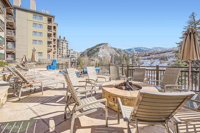 view of patio featuring a fire pit and a mountain view