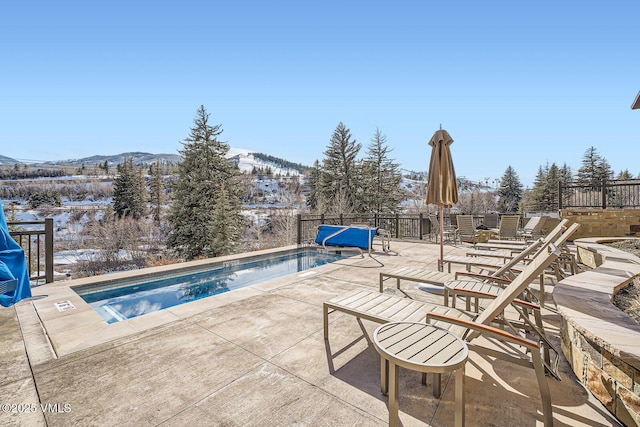 pool featuring a patio area and a mountain view