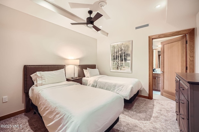 bedroom featuring ceiling fan, connected bathroom, light colored carpet, visible vents, and baseboards