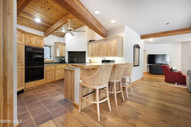 66 Arrowhead Cir Unit 13, Edwards, CO 81632 - kitchen featuring light brown cabinetry, a breakfast bar area, a peninsula, and recessed lighting