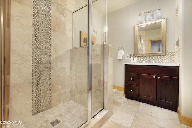 66 Arrowhead Cir Unit 13, Edwards, CO 81632 - bathroom featuring a stall shower, vanity, backsplash, tile patterned floors, and baseboards