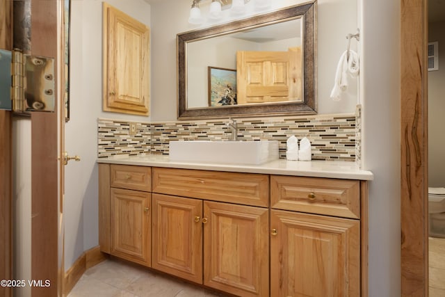 66 Arrowhead Cir Unit 13, Edwards, CO 81632 - bathroom featuring vanity, backsplash, toilet, and tile patterned flooring