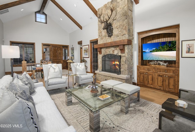 233 Wildflower Ln, Wolcott, CO 81655 - living area featuring high vaulted ceiling, beam ceiling, light wood-style floors, and a stone fireplace