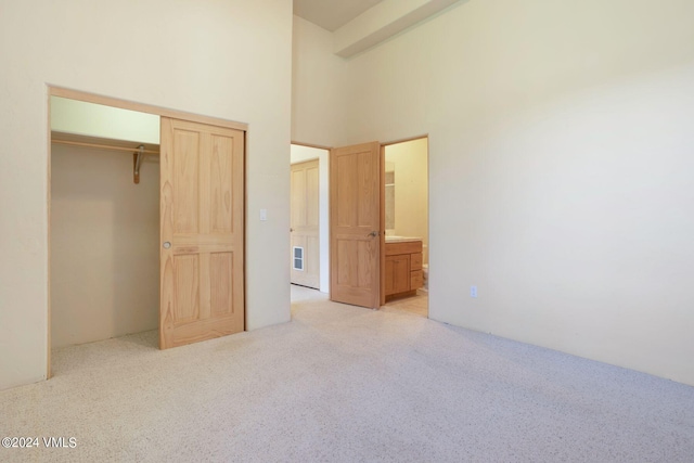 4765 Wildridge Rd, Avon, CO 81620 - unfurnished bedroom featuring carpet floors, a closet, connected bathroom, and a towering ceiling