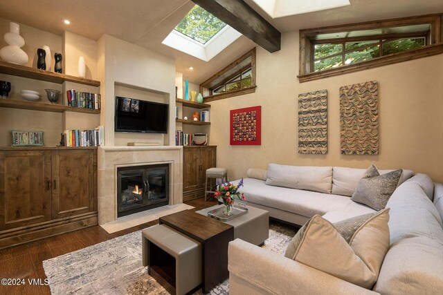 living room featuring wood-type flooring, high vaulted ceiling, and beam ceiling