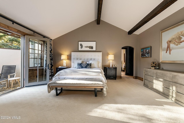 carpeted bedroom with beam ceiling, high vaulted ceiling, and access to outside