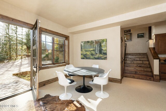 dining area featuring light carpet