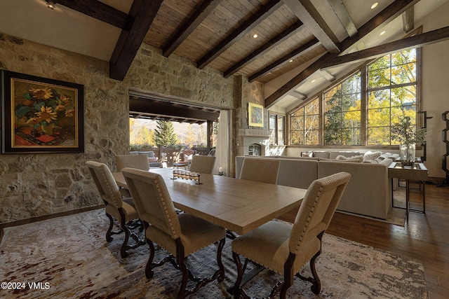 dining space featuring beamed ceiling, hardwood / wood-style floors, wooden ceiling, and high vaulted ceiling