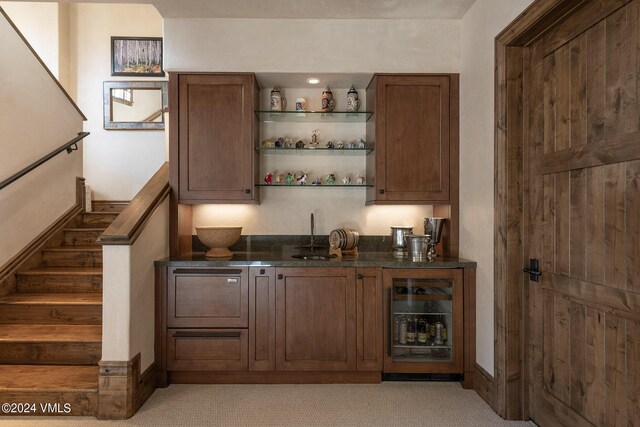 bar featuring light colored carpet and sink