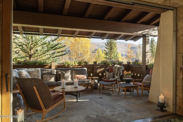 view of patio / terrace with an outdoor hangout area and a mountain view