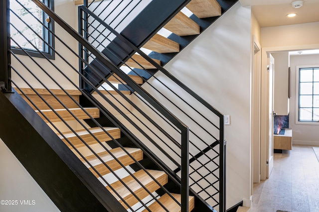 stairway featuring baseboards and wood finished floors