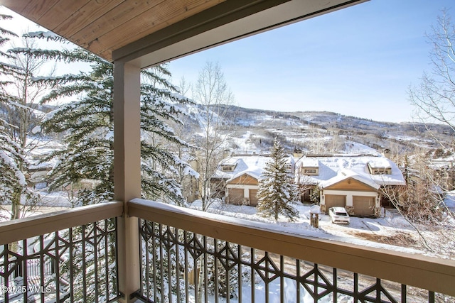 view of snow covered back of property