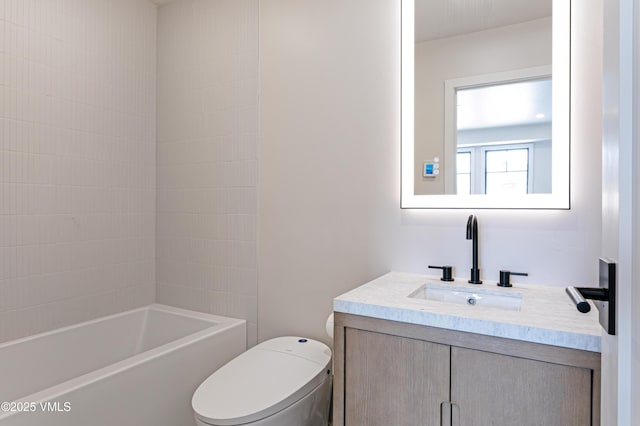 bathroom featuring bathtub / shower combination, vanity, and toilet