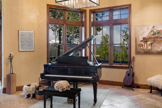 misc room with a wealth of natural light and a high ceiling