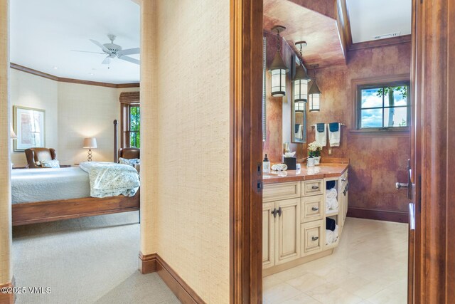 bathroom featuring crown molding, ceiling fan, a healthy amount of sunlight, and vanity