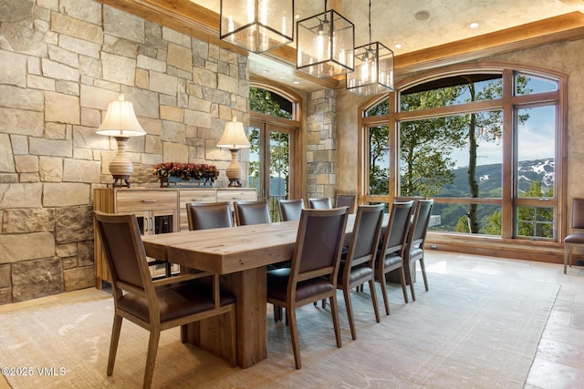 dining space with a mountain view, a notable chandelier, and a high ceiling