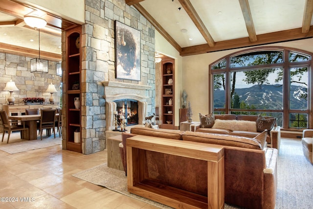 living room featuring beamed ceiling, a fireplace, a mountain view, and high vaulted ceiling