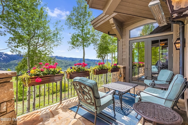 wooden deck with a mountain view and french doors