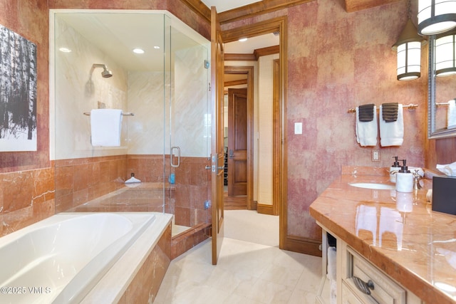 bathroom featuring shower with separate bathtub and vanity