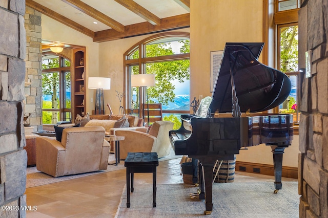 interior space with beam ceiling and high vaulted ceiling