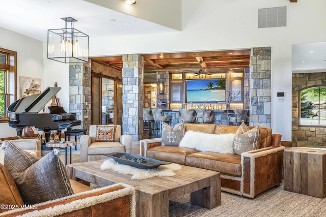 46 Jasmine, Avon, CO 81620 - living room featuring beamed ceiling, healthy amount of natural light, carpet flooring, and ornate columns